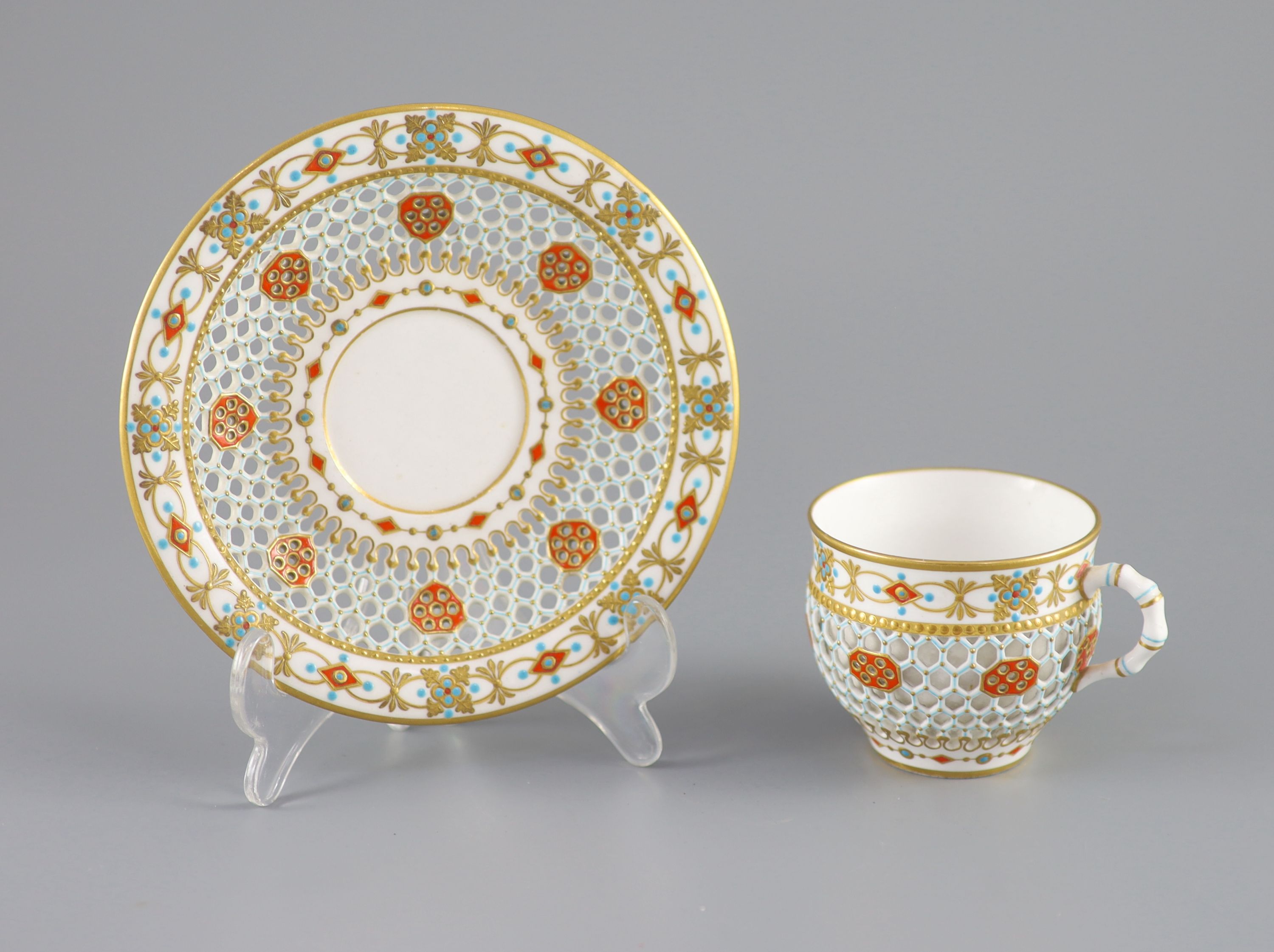 A Royal Worcester 'jewelled' and reticulated cup and saucer